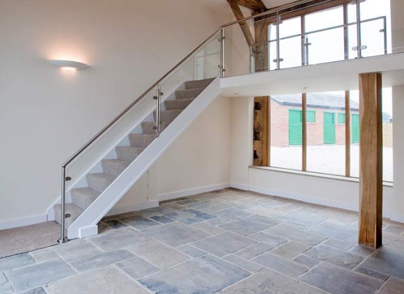 An open staircase leading to galleried landing overlooking the spacious living area below.