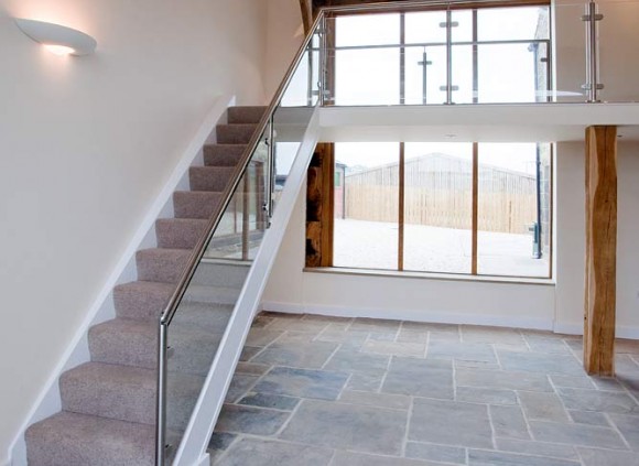 An open staircase leading to galleried landing overlooking the spacious living area below.